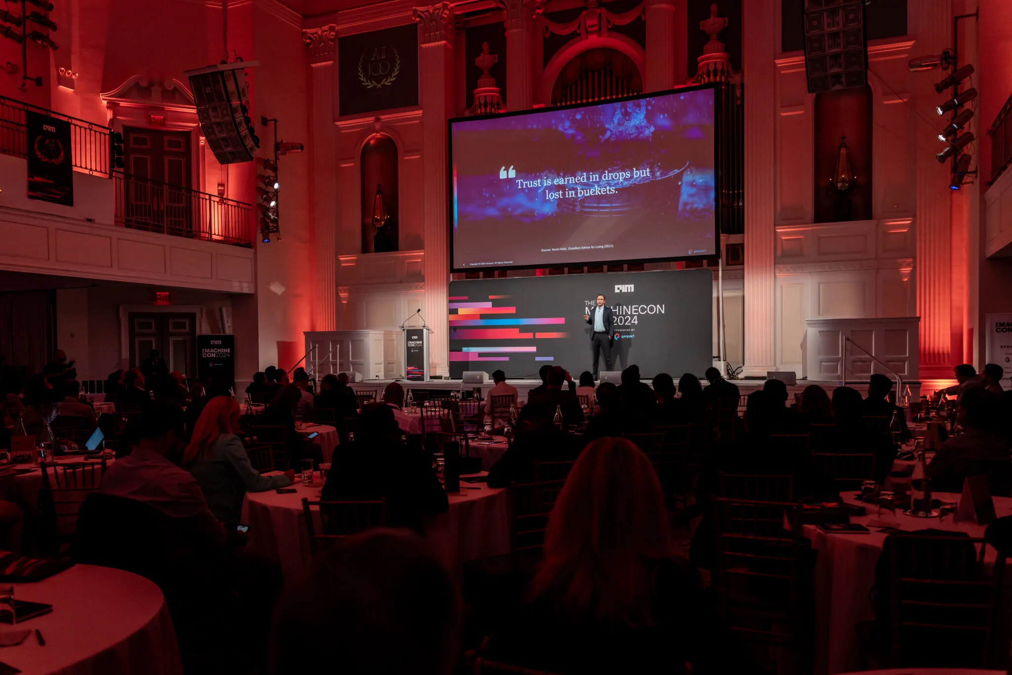 Speaker on stage with presentation at MachineCon New York 2024