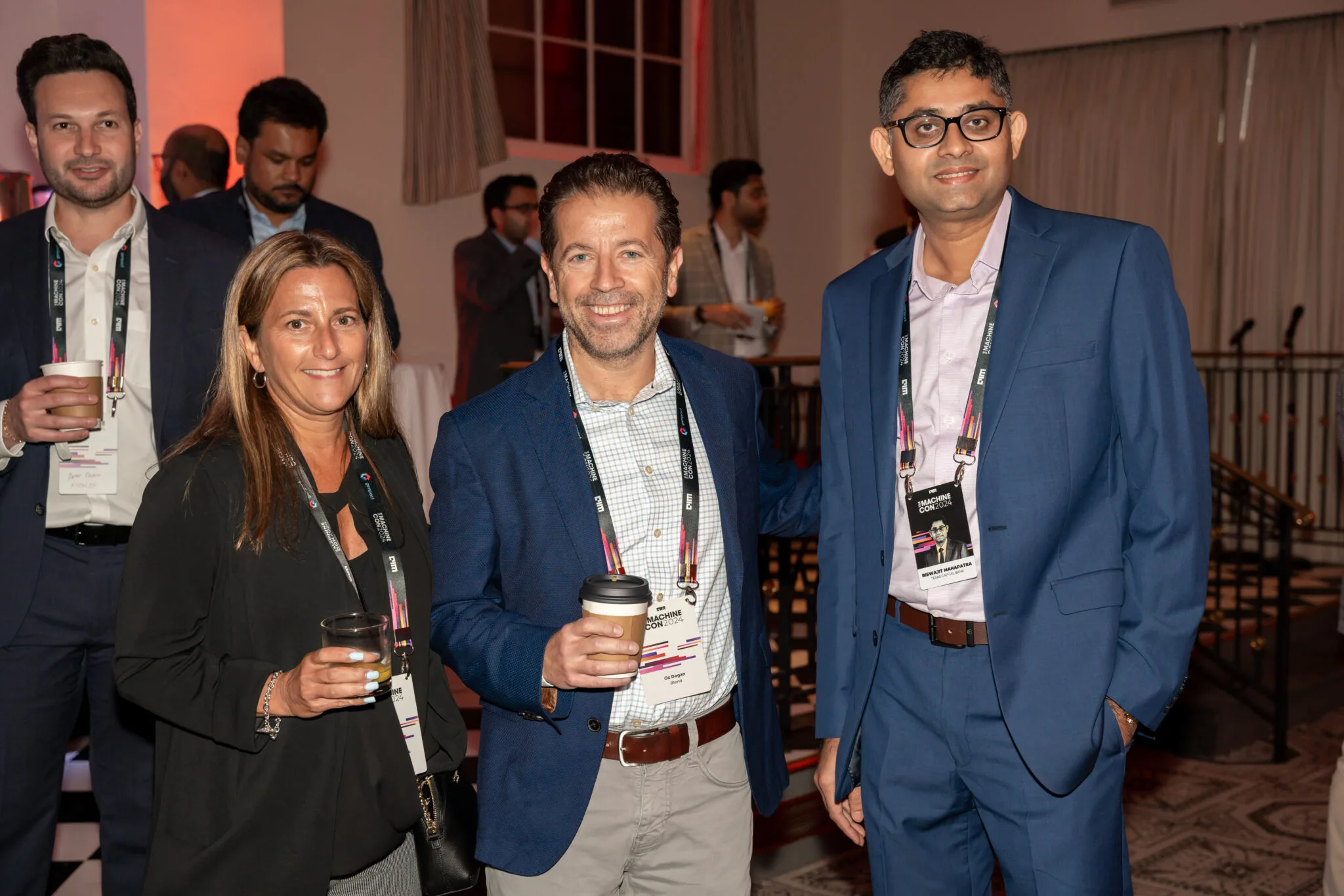 Attendees networking with drinks at MachineCon New York 2024