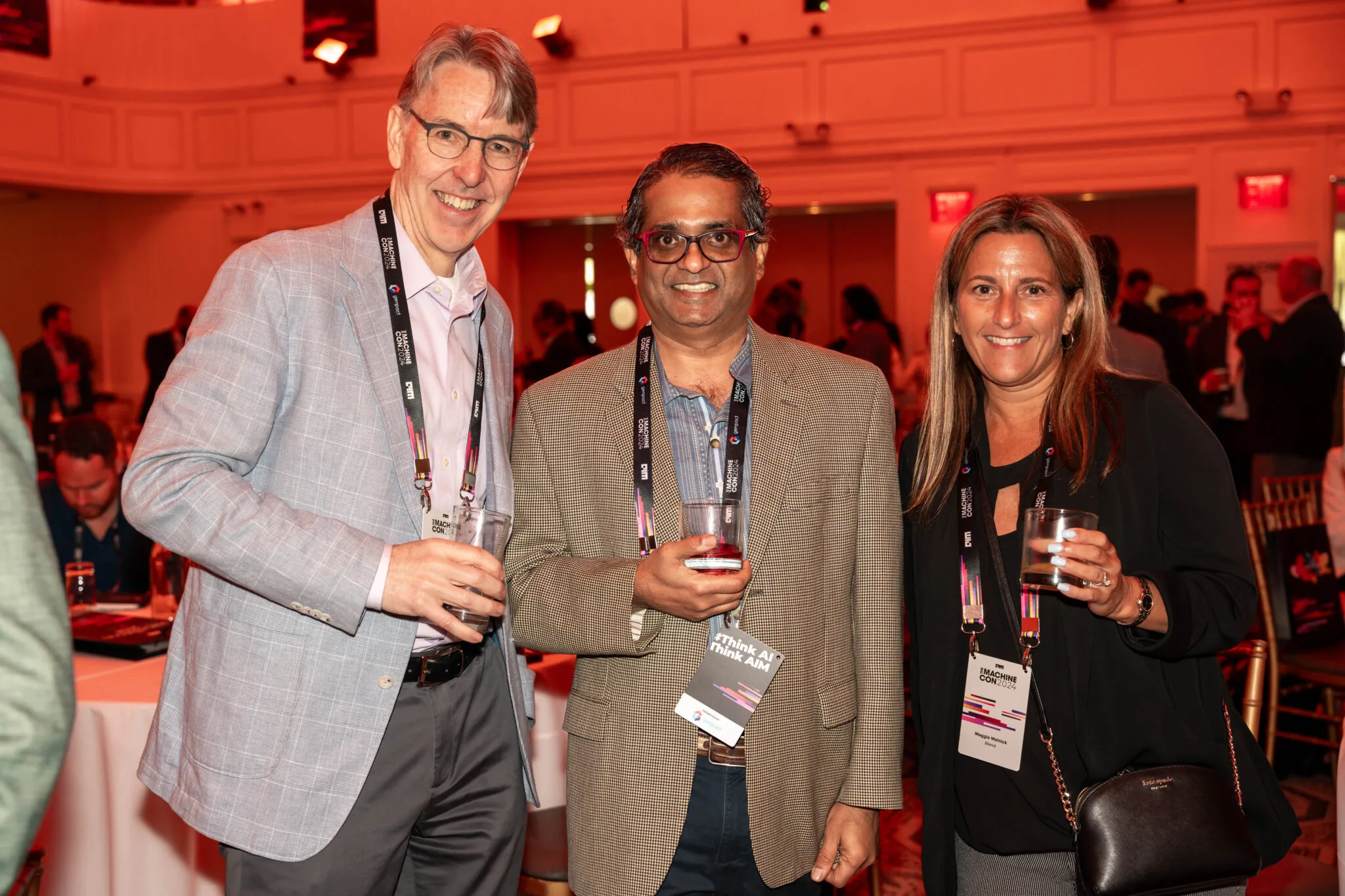 Attendees networking with drinks at MachineCon New York 2024