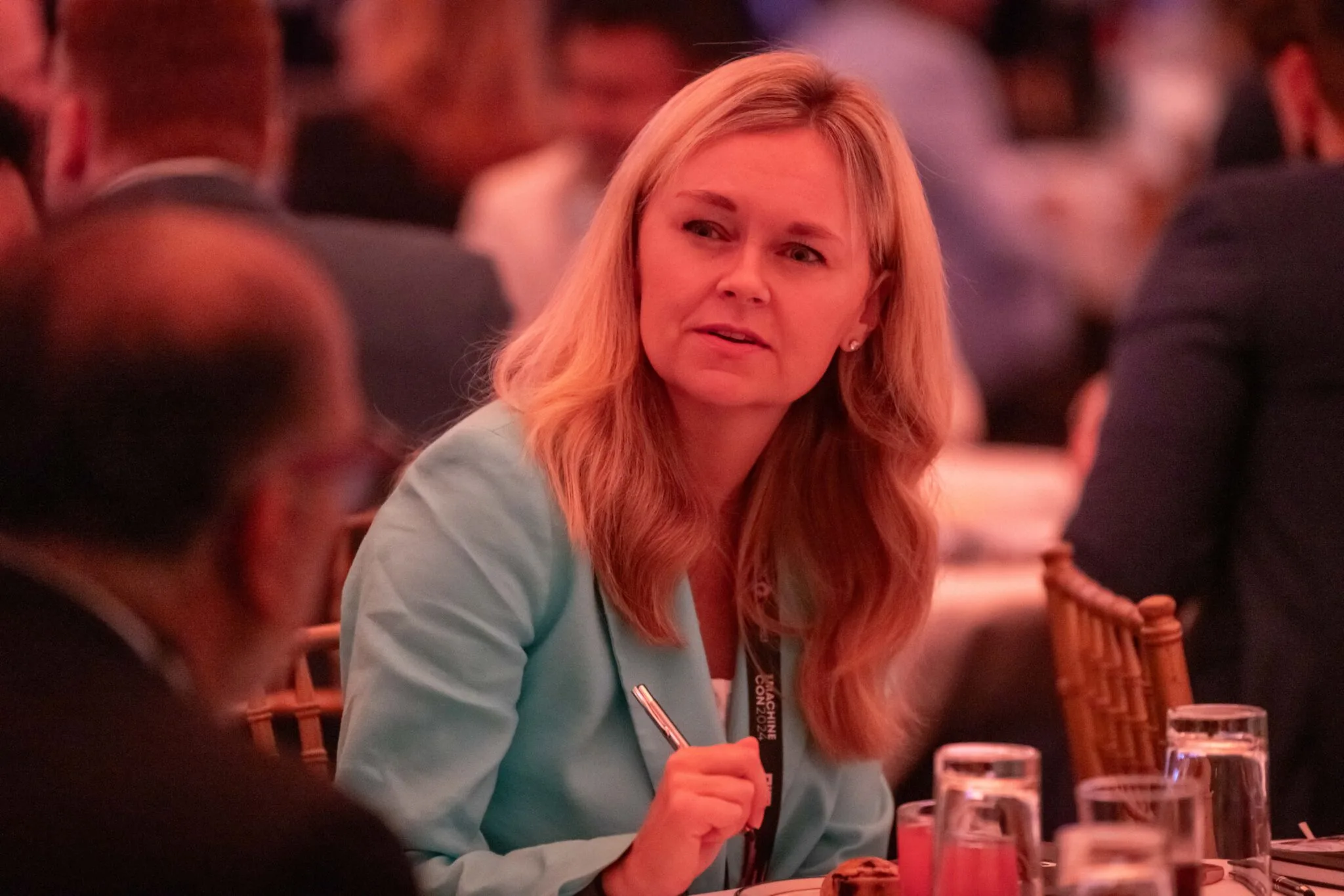 Attendee listening at table at MachineCon New York 2024