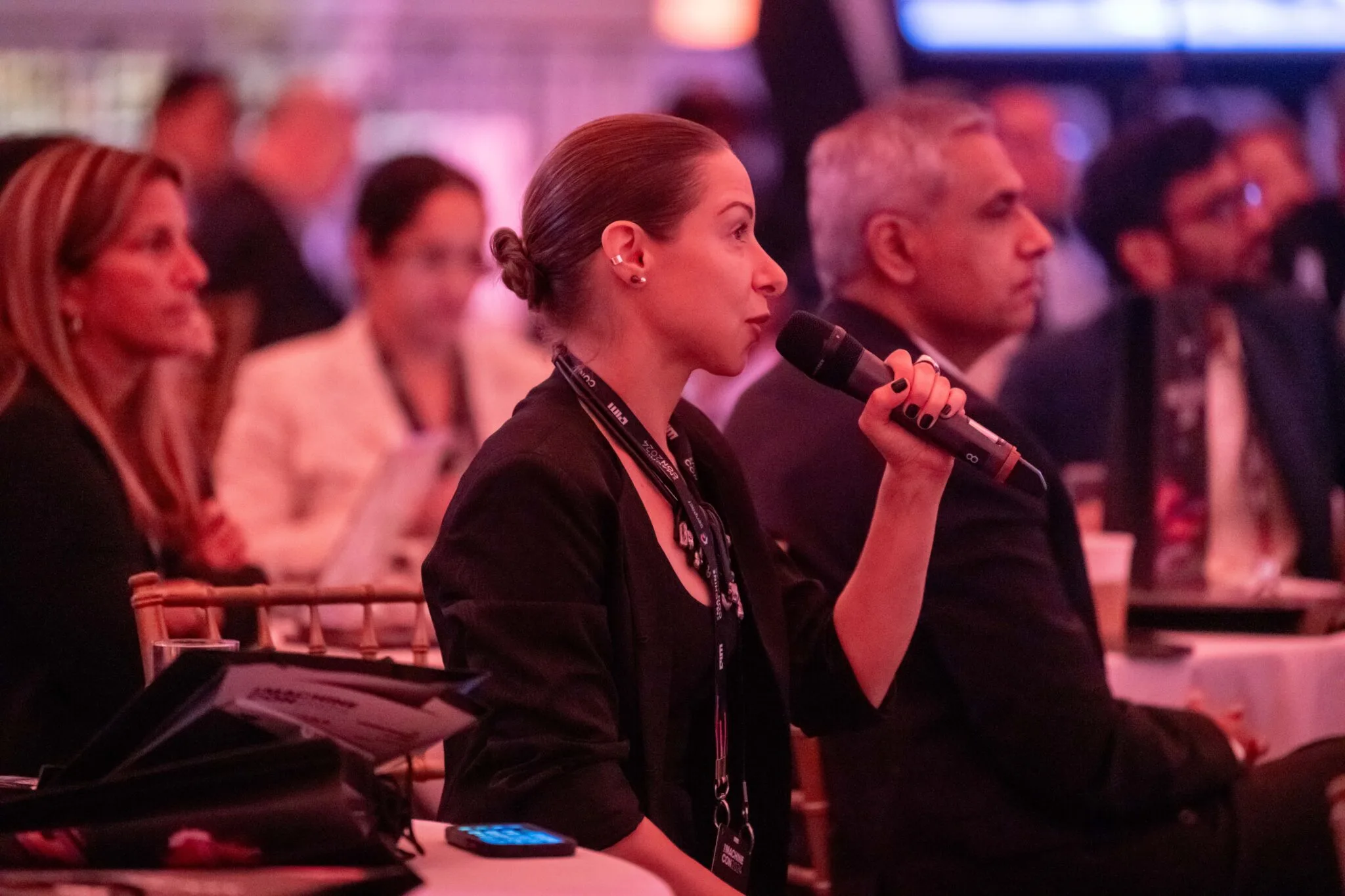 Audience member speaking into microphone at MachineCon New York 2024