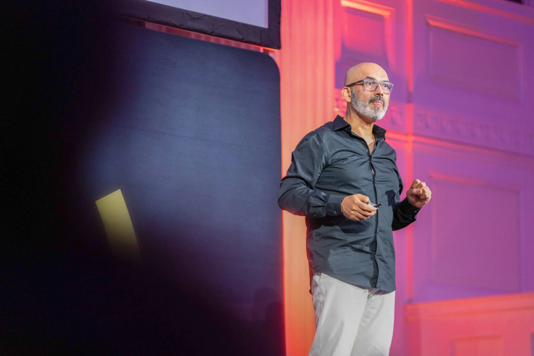 Speaker on stage with presentation at MachineCon New York 2025