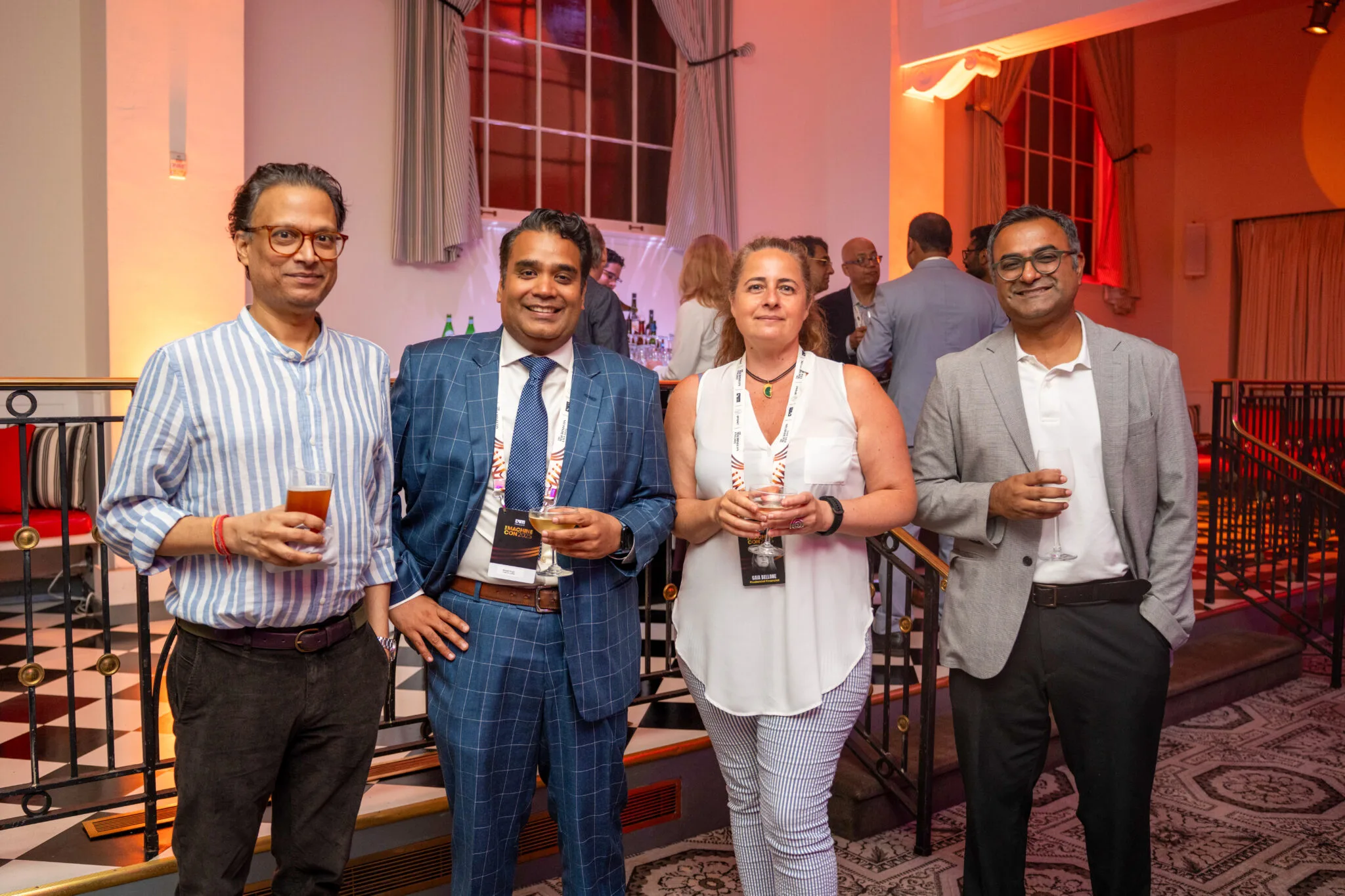 Group of attendees holding drinks at MachineCon New York 2025