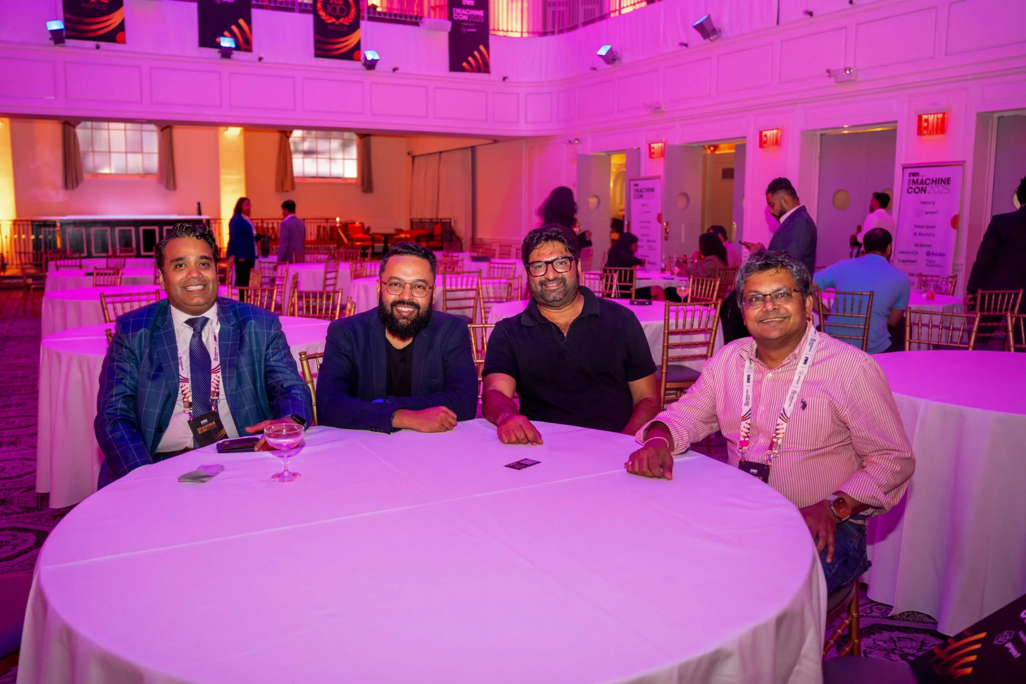 Four attendees sitting at round table at MachineCon New York 2025