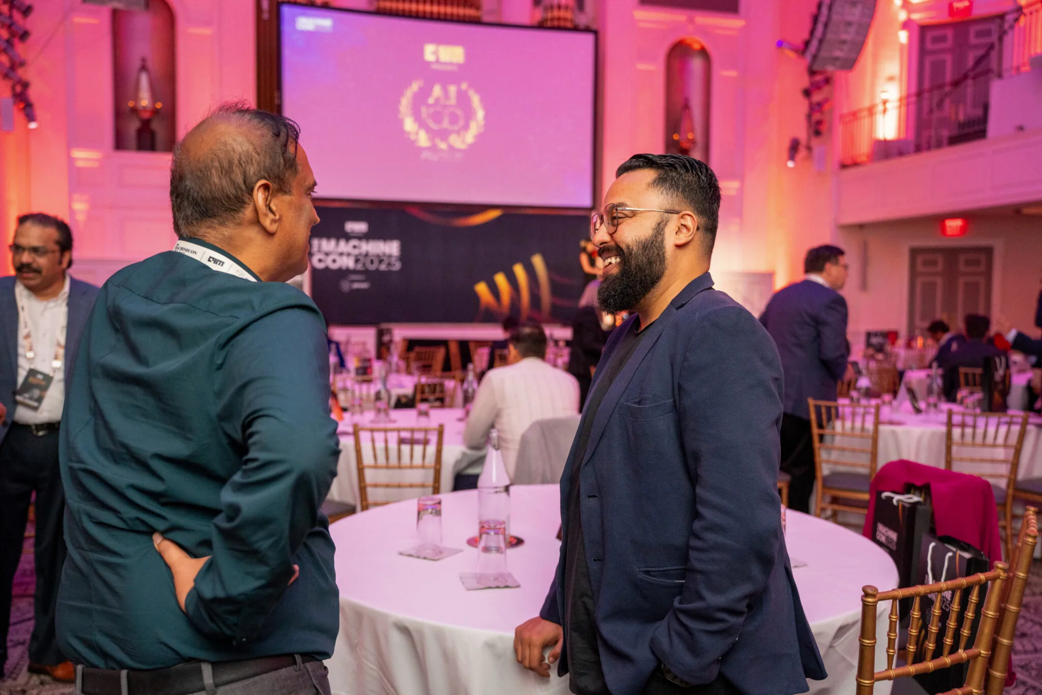 Attendees networking by round table at MachineCon New York 2025